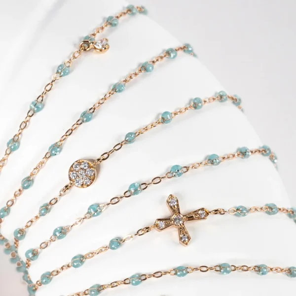 bracelets gigi clozeau en or rose résine aqua motif puce diamants, croix vintage et diamant